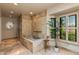 Beautiful bathroom featuring a soaking tub, walk-in shower, and natural light at 7330 E Palo Verde Dr # 1, Scottsdale, AZ 85250