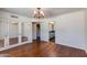 Bright bedroom with hardwood floors, mirrored closet doors, and chandelier at 7330 E Palo Verde Dr # 1, Scottsdale, AZ 85250