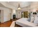 This main bedroom offers a fireplace, tray ceiling, and private balcony access for relaxation at 7330 E Palo Verde Dr # 1, Scottsdale, AZ 85250