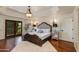 This main bedroom features tray ceilings, stylish decor, and private balcony access at 7330 E Palo Verde Dr # 1, Scottsdale, AZ 85250