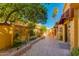 Charming courtyard featuring brick-paved pathways and lush desert landscaping at 7330 E Palo Verde Dr # 1, Scottsdale, AZ 85250