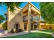Charming home exterior with a balcony, well-manicured lawn, and mature trees at 7330 E Palo Verde Dr # 1, Scottsdale, AZ 85250