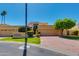 Spacious home showcasing a 2-car garage, mature landscaping, and a second-story balcony, blending style and functionality at 7330 E Palo Verde Dr # 1, Scottsdale, AZ 85250