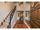 Grand foyer features a winding staircase, wood flooring, and decorative mirrors, exuding elegance and sophistication at 7330 E Palo Verde Dr # 1, Scottsdale, AZ 85250