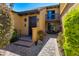 Inviting front entrance with charming walkway, lovely fountain, and a second-story balcony, creating a warm welcome at 7330 E Palo Verde Dr # 1, Scottsdale, AZ 85250