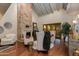 Elegant living room showcasing a high ceiling, decorative fireplace, hardwood floors, and stylish seating, creating a cozy ambiance at 7330 E Palo Verde Dr # 1, Scottsdale, AZ 85250