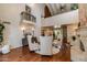Elegant living room showcasing a fireplace, a high ceiling, an upper balcony, and hardwood floors, creating a cozy ambiance at 7330 E Palo Verde Dr # 1, Scottsdale, AZ 85250