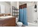 Well-lit bathroom featuring a shower-tub combo, toilet, and vanity with storage at 7807 E Main St # E-38, Mesa, AZ 85207