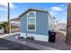 Pleasant light blue home with carport, trash receptacle and low-maintenance desert landscaping at 7807 E Main St # E-38, Mesa, AZ 85207