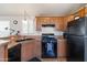 Bright kitchen with light wood cabinets and black appliances at 7807 E Main St # E-38, Mesa, AZ 85207