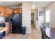 Open floor plan featuring black appliances, wood cabinets, and laundry access at 7807 E Main St # E-38, Mesa, AZ 85207