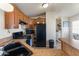 Kitchen featuring wood cabinets and black appliances near the laundry area at 7807 E Main St # E-38, Mesa, AZ 85207