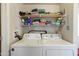 Laundry room with washer, dryer, and shelving for organized storage at 7807 E Main St # E-38, Mesa, AZ 85207