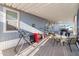 Spacious covered patio featuring a grill, seating area, and a view of a vintage motorcycle at 7807 E Main St # E-38, Mesa, AZ 85207