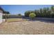 An appealing backyard with low-maintenance gravel, mature trees, and a defined grassy area at 801 E Piute Ave, Phoenix, AZ 85024