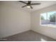This cozy bedroom features neutral paint, carpeted floor and large window at 801 E Piute Ave, Phoenix, AZ 85024