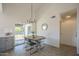 Dining area featuring modern light fixture, gray cabinets, table with seating for four, and backyard access at 801 E Piute Ave, Phoenix, AZ 85024