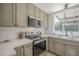 Bright kitchen featuring stainless steel appliances, stone countertops, and ample cabinet space at 801 E Piute Ave, Phoenix, AZ 85024