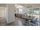Modern kitchen and dining area with stainless appliances, gray cabinets, and backyard views at 801 E Piute Ave, Phoenix, AZ 85024