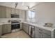 Beautiful kitchen featuring stainless steel appliances, stone countertops, and ample cabinet space at 801 E Piute Ave, Phoenix, AZ 85024