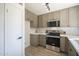 Well-lit kitchen featuring stainless steel appliances, bright countertops, and ample cabinet space at 801 E Piute Ave, Phoenix, AZ 85024