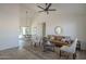 Bright living room featuring tile floors, ceiling fan, leather couch, and access to dining area at 801 E Piute Ave, Phoenix, AZ 85024