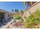 Landscaped backyard featuring a cozy patio seating area and custom rock water feature with lush landscaping at 816 E Amberwood Dr, Phoenix, AZ 85048