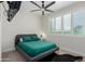 Bedroom featuring a ceiling fan, plantation shutters, and unique animal skin rug at 816 E Amberwood Dr, Phoenix, AZ 85048