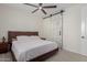 Bedroom with a ceiling fan and decorative barn door that leads to the bathroom at 816 E Amberwood Dr, Phoenix, AZ 85048