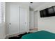 Bedroom with sliding closet doors, ceiling fan, and television at 816 E Amberwood Dr, Phoenix, AZ 85048
