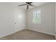 Neutral bedroom featuring carpet, fan, shuttered window, and closet at 816 E Amberwood Dr, Phoenix, AZ 85048