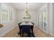 Elegant dining room with shuttered windows, hardwood floors, and a stylish chandelier above the table at 816 E Amberwood Dr, Phoenix, AZ 85048