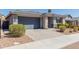Charming single-story home with a gray exterior, well-manicured landscaping, and a paved driveway leading to the garage at 816 E Amberwood Dr, Phoenix, AZ 85048