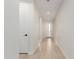 Hallway featuring hardwood floors, white walls, doors and trim, leading to the front door at 816 E Amberwood Dr, Phoenix, AZ 85048