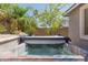 Outdoor hot tub features a cozy backyard setting with tropical plants and a privacy wall at 816 E Amberwood Dr, Phoenix, AZ 85048