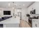 Open-concept kitchen with a large island, modern lighting, and stainless steel refrigerator at 816 E Amberwood Dr, Phoenix, AZ 85048