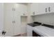 Convenient laundry room featuring storage and appliances at 816 E Amberwood Dr, Phoenix, AZ 85048
