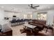 Open-concept living room with hardwood floors, a large leather sofa, an island kitchen, and a dining area at 816 E Amberwood Dr, Phoenix, AZ 85048