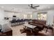 Open-concept living room with hardwood floors, a large leather sofa, an island kitchen, and a dining area at 816 E Amberwood Dr, Phoenix, AZ 85048
