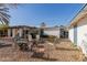 Spacious backyard with gravel landscaping, fire pit, and various seating arrangements at 825 W 12Th St, Tempe, AZ 85281
