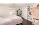 Bedroom featuring hardwood floors, an easel and a sliding closet door creating a creative and organized space at 825 W 12Th St, Tempe, AZ 85281