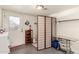 This laundry room features a folding screen, convenient storage shelves, and tile floors at 825 W 12Th St, Tempe, AZ 85281