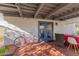 Covered patio with red tile flooring and blue French doors, perfect for outdoor enjoyment at 825 W 12Th St, Tempe, AZ 85281