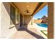 Covered back patio offers a fan and view of the private pool and backyard at 8515 W Peppertree Ln, Glendale, AZ 85305