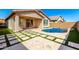 Inviting backyard with a custom pool, spacious patio, and manicured landscaping at 8515 W Peppertree Ln, Glendale, AZ 85305