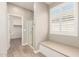 Bright bathroom featuring a glass shower, a window with shutters, and a built-in bench at 8515 W Peppertree Ln, Glendale, AZ 85305
