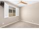 Bedroom with carpeted floor, a window with shutters and a ceiling fan at 8515 W Peppertree Ln, Glendale, AZ 85305