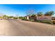 Community entrance with stone accents and landscaped median at 8515 W Peppertree Ln, Glendale, AZ 85305