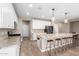 Well-lit kitchen featuring granite countertops, an island with seating, and stainless steel appliances at 8515 W Peppertree Ln, Glendale, AZ 85305