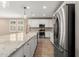 Bright kitchen with granite countertops, stainless steel appliances, and a large island with seating at 8515 W Peppertree Ln, Glendale, AZ 85305